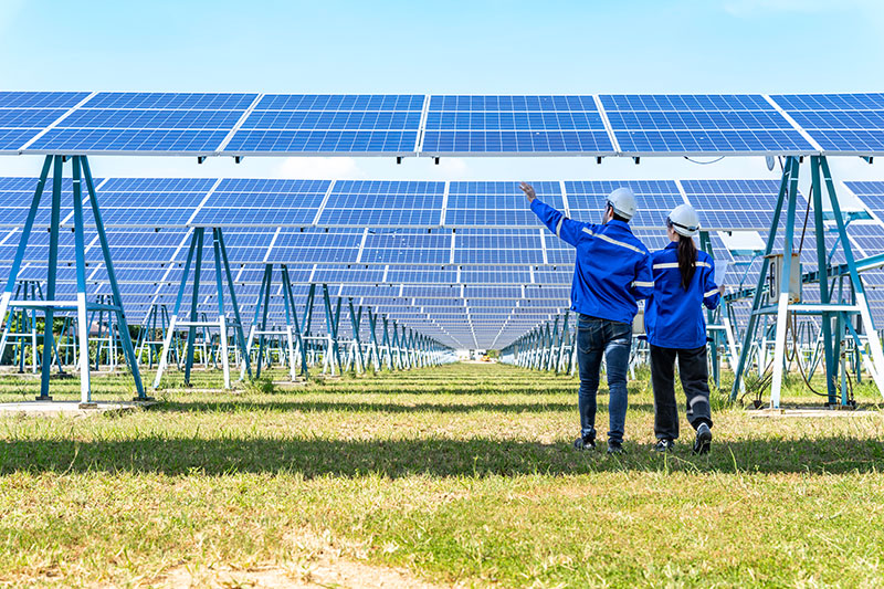 Engineers inspecting solar panels