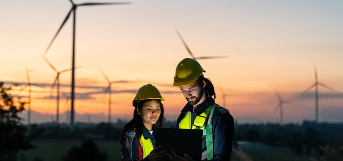 Workers inspecting wind turbines