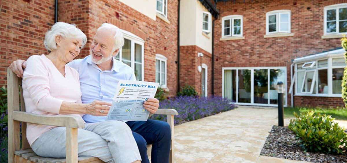 Two retirement village tenants sitting outside a unit building where Power Consumption Metering for Tenancy Billing is crucial when invoicing for energy usage