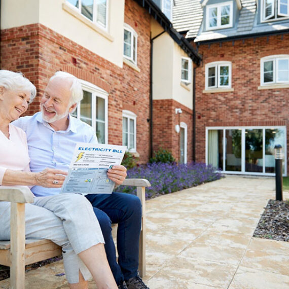 Two retirement village tenants sitting outside a unit building where Power Consumption Metering for Tenancy Billing is crucial when invoicing for energy usage