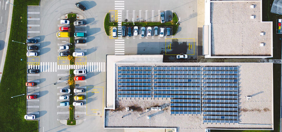 Solar panels on a commercial building where Solar Energy Monitoring vs Inverter Monitoring is a consideration